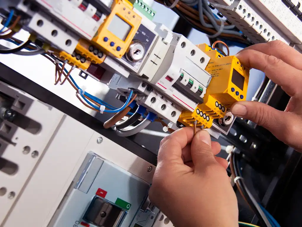 Electrician installing a circuit breaker